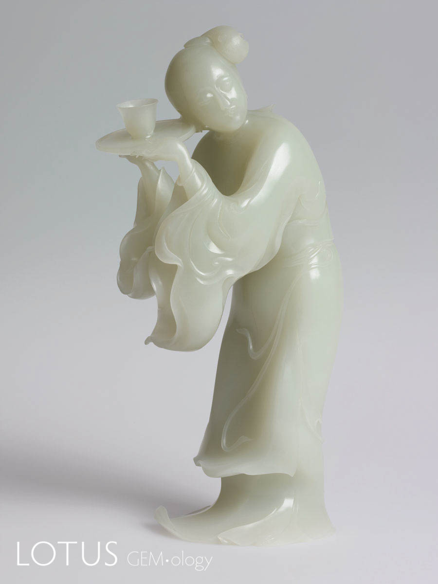 Mutual Respect by Yu Jing. Hetian "mutton fat" nephrite from Xinjiang, China. This piece is remarkable for the high-quality of the jade used, but also for the position of the figure, which necessitated a huge amount of material wastage. Most carvers would never dare to waste so much expensive rough jade. 20 x 8.9 x 5.9 cm; 2002. Photo: Huang Guojun. Click on the photo for a larger image