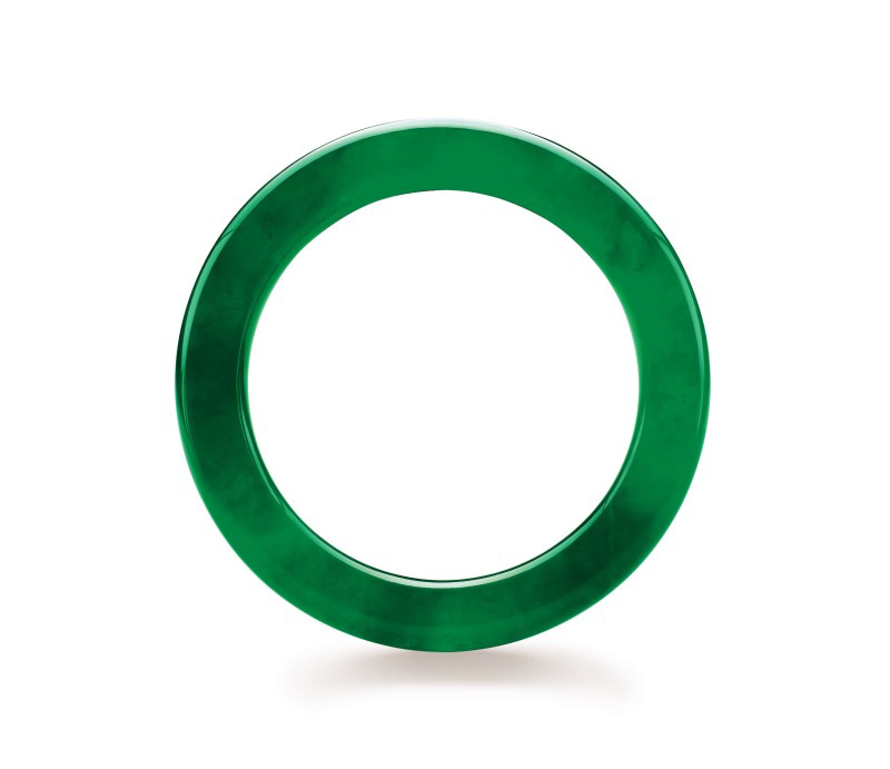 Figure 6. Believed to date back at least four millennia in China, the jade bangle is both one of the oldest and one of the most important pieces of jewelry in the Chinese culture. This superb jadeite bangle sold for US$2,576,600 at the Christie's Hong Kong November 1999 auction. The interior diameter is 49.50 mm; the jadeite is 8.36 mm thick. Photo courtesy of and © Christie's Hong Kong and Tino Hammid.