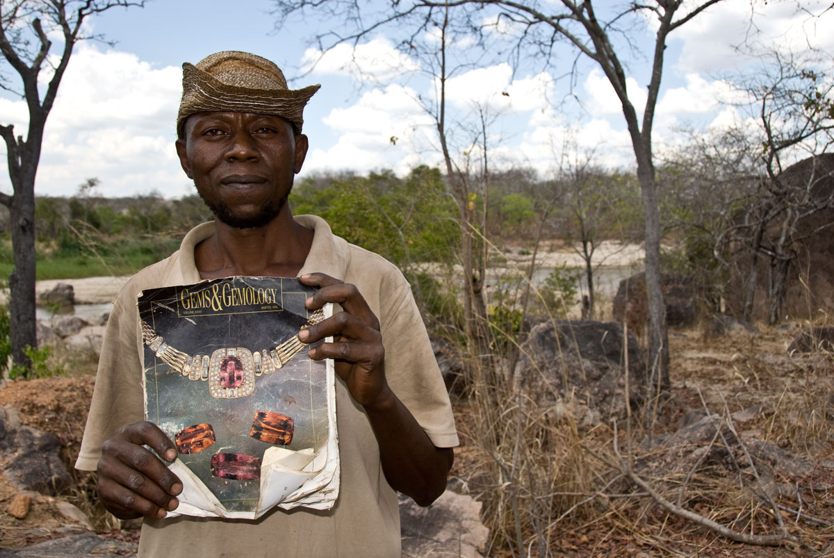 Miner Joseph Mayunga displays one of his prize possessions, a Gems & Gemology magazine that includes an article on the gems of Tanzania, given to him by a Sri Lankan dealer after a successful chrysoberyl deal. At the time of our visit in October, 2007, Joseph had been living and mining at the Muhuwesi river for more than seven years. Photo: Richard W. Hughes