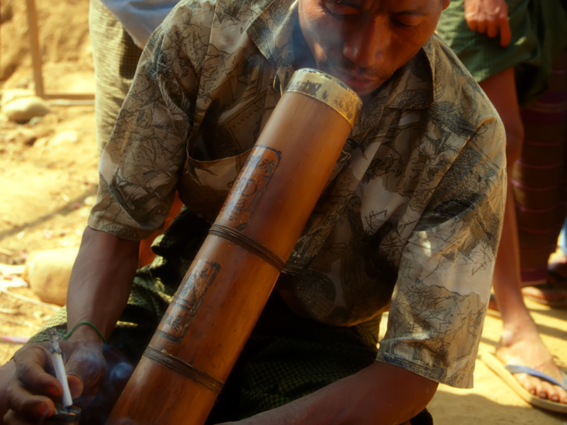 A miner takes a break to have a cigarette at Hpakangyi. Such Chinese bamboo water pipes (bongs) are also used for smoking opium, to which many miners are addicted. Inset: Despite its toughness, much jade is polished on bamboo lathes, such as this one in Mandalay's jade market.