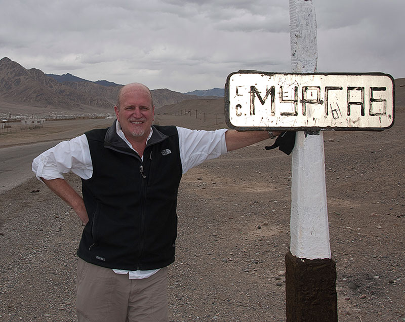 Richard Hughes on the outskirts of Murgab, in the remote Badakhshan region of Tajikistan. Imagine a photo of you next to the sign. Photo © Richard W. Hughes.
