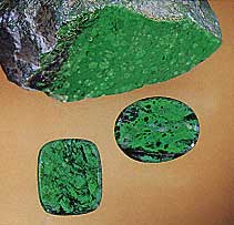Figure B-3. A "cousin" to jade, maw-sit-sit is an attractive ornamental stone that is an intergrowth mainly of albite, clinochlore, kosmochlor, chromian jadeite, and eckermannitic amphibole. These two maw-sit-sit cabochons weigh 9.87 ct (oval) and 8.48 ct. Courtesy of Pala International; photo © Harold & Erica Van Pelt.