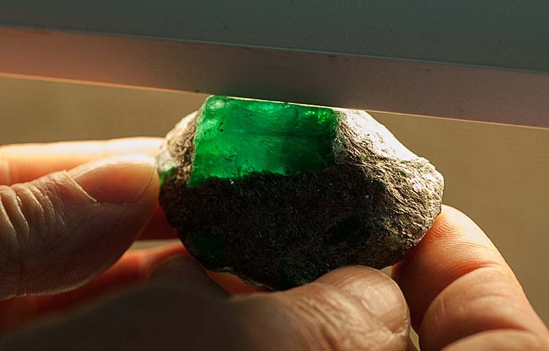 Lotus Gemology Bangkok: A large Russian emerald crystal still embedded in the mica schist. Photo: Richard W. Hughes