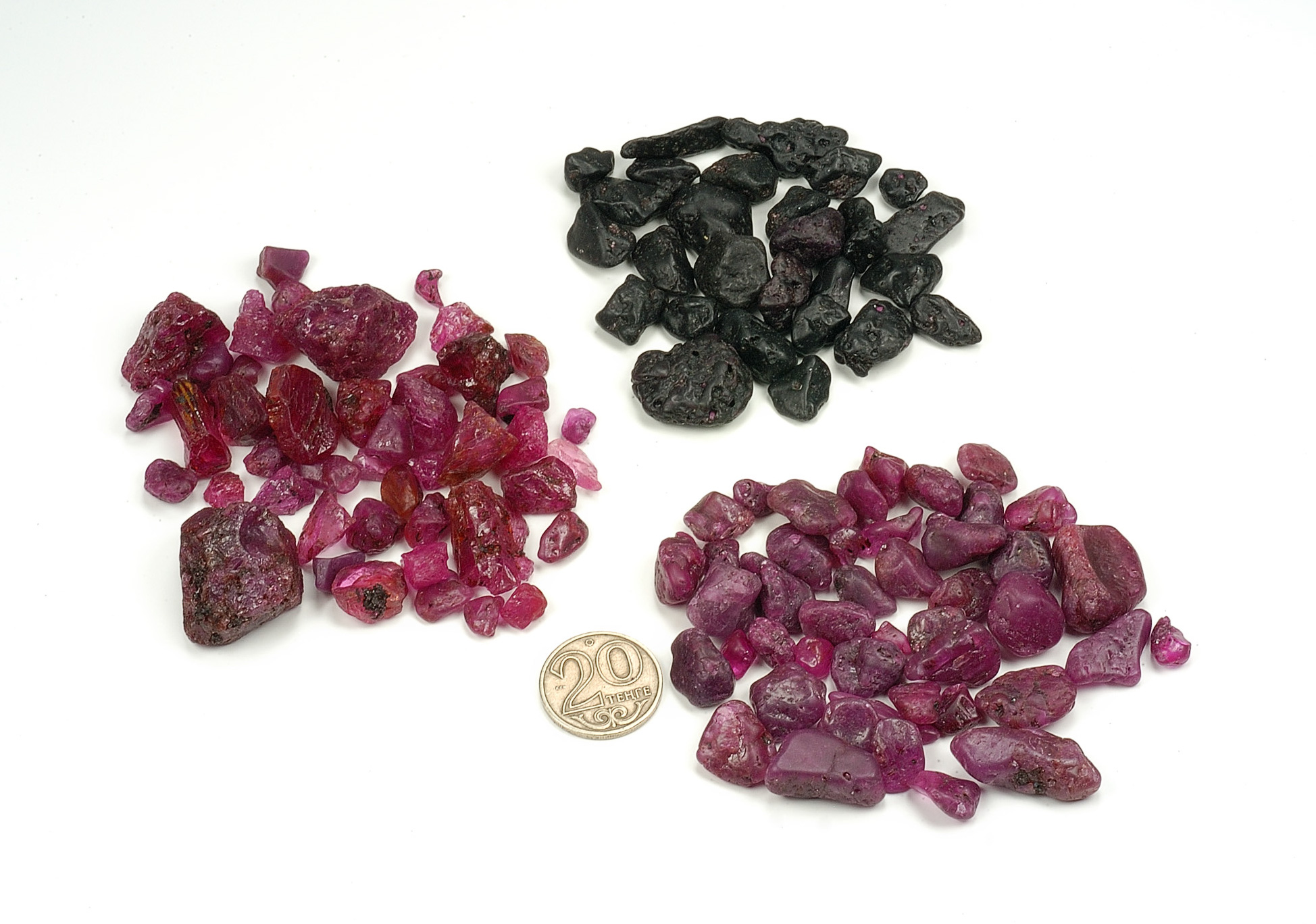 Three lots of "ruby" reputed to be from Tajikistan and obtained from a source in Tashkent, Uzbekistan. While the lower two are indeed ruby, the top lot proved to be dark red garnet. Photo: Wimon Manorotkul/Pala International