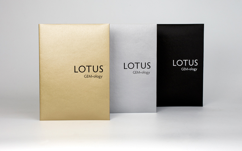Lotus Gold, Silver and Black softcover reports. Lotus Gemology's report covers are color coded so that one can quickly understand the identity of the gem. Rather than hiding treatment information behind arcane codes, Lotus Gemology is the world's only lab that makes clear the treatment status. Lotus Gold is reserved for untreated gems, Lotus Silver for gems treated by industry-standard techniques and Lotus Black for heavily treated or man-made gems.
