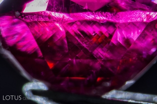 After this ruby grew, it was exposed to high pressure, causing certain planes of atoms to glide into a twinned position. This secondary “polysynthetic” twinning takes place along the rhombohedron faces and is common in many corundums. Twin planes cross at 86.1 and 93.9° angles.