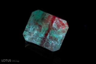 Chalky fluorescence, visible in longwave ultraviolet illumination, unmasks filler in the fissures of this emerald.
