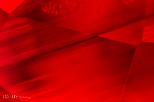 While straight growth zoning is often seen as a sign that corundum is natural, this is not always. This flux synthetic ruby displays sharp straight growth zoning.