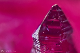 A small twin crystal attached to a larger Knischka ruby crystal.