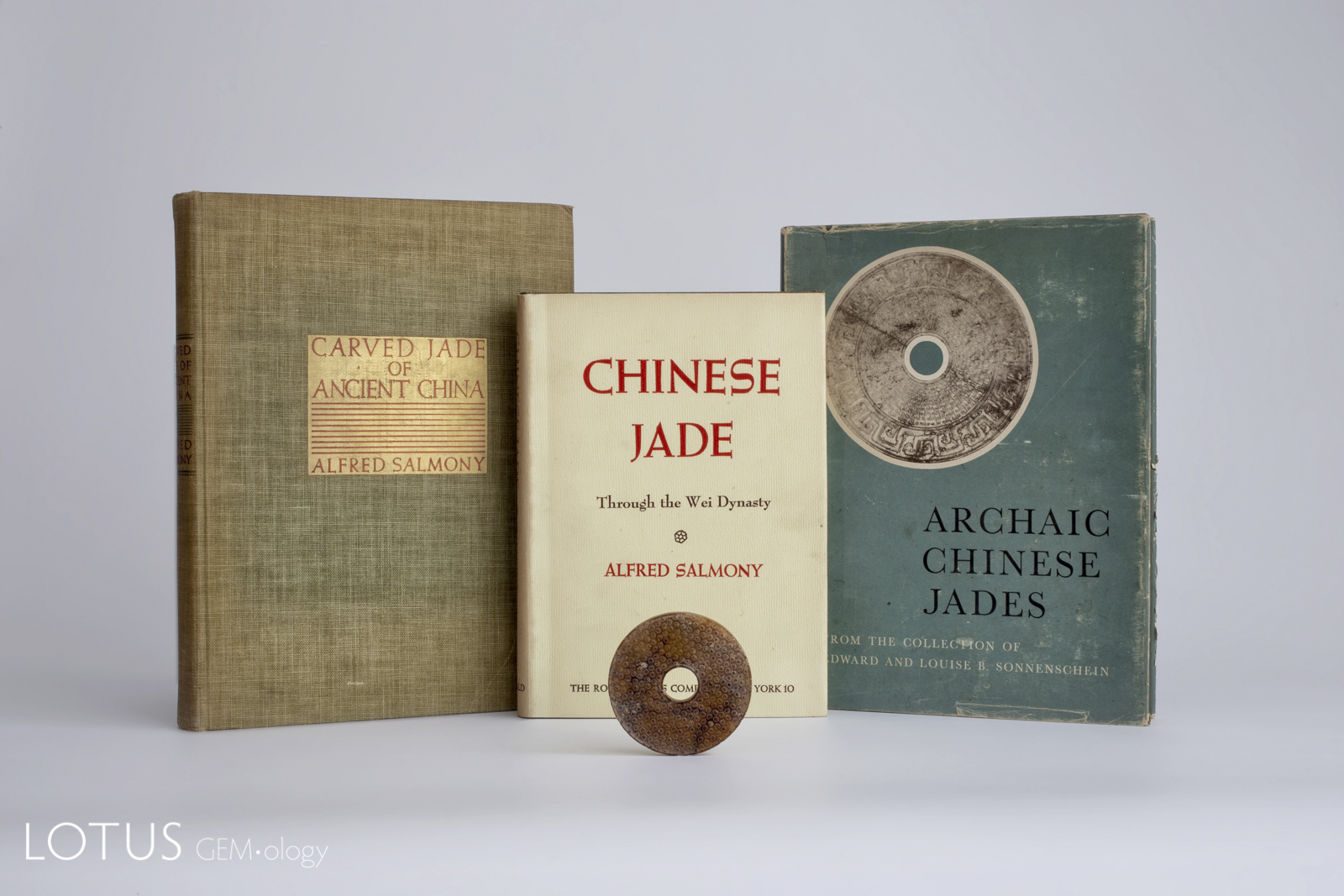 Alfred Salmony's three important books on jade from 1938, 1963 (published posthumously) and 1952, along with a modern replica of an archaic Chinese jade bi.