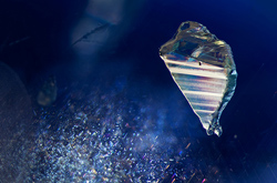 An apatite crystal appears to float, suspended over a rutile silk cloud in a star sapphire.