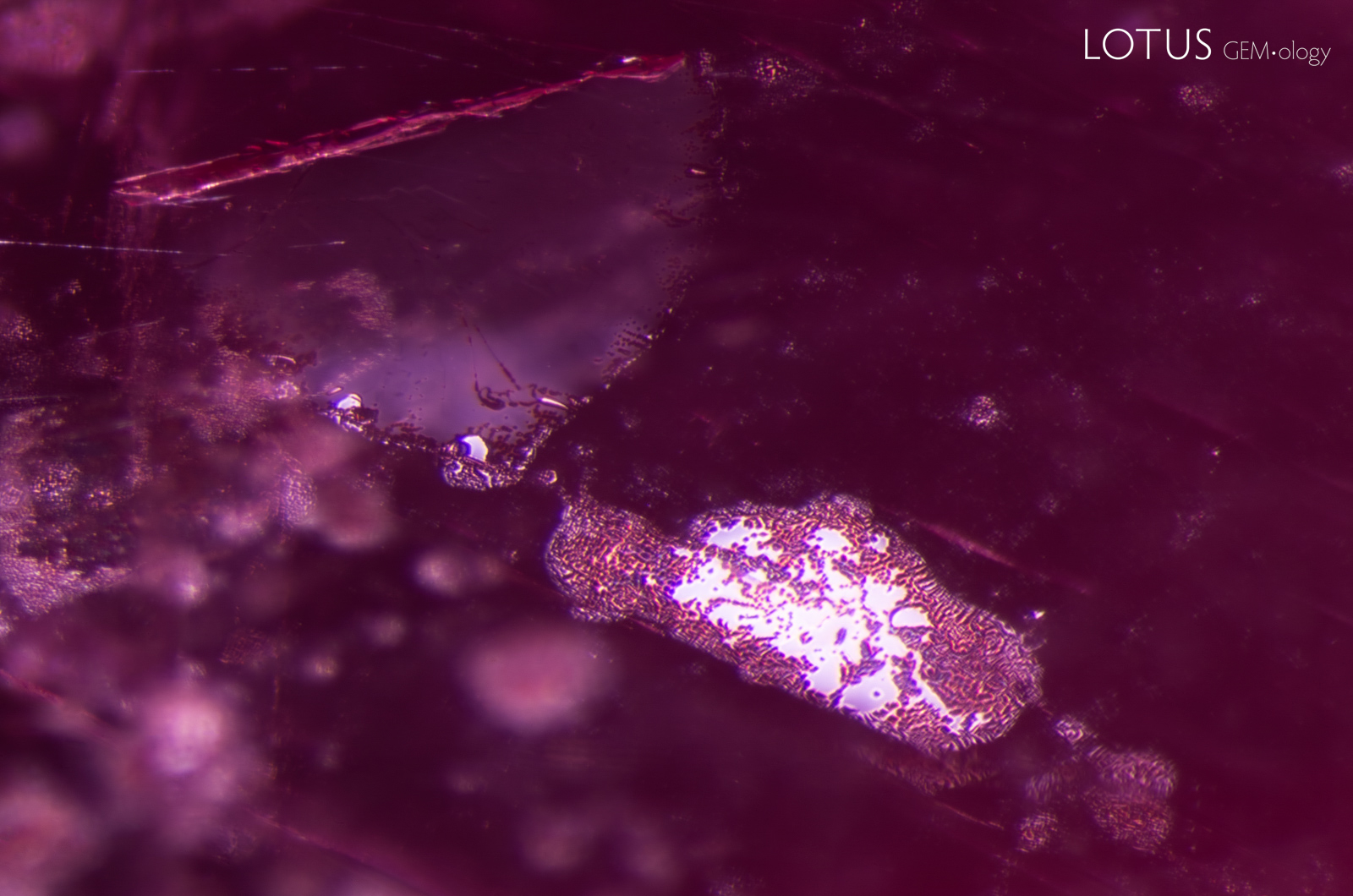 Partially healed fissures with melted channels and glassy areas provide evidence that this spinel underwent heat treatment.