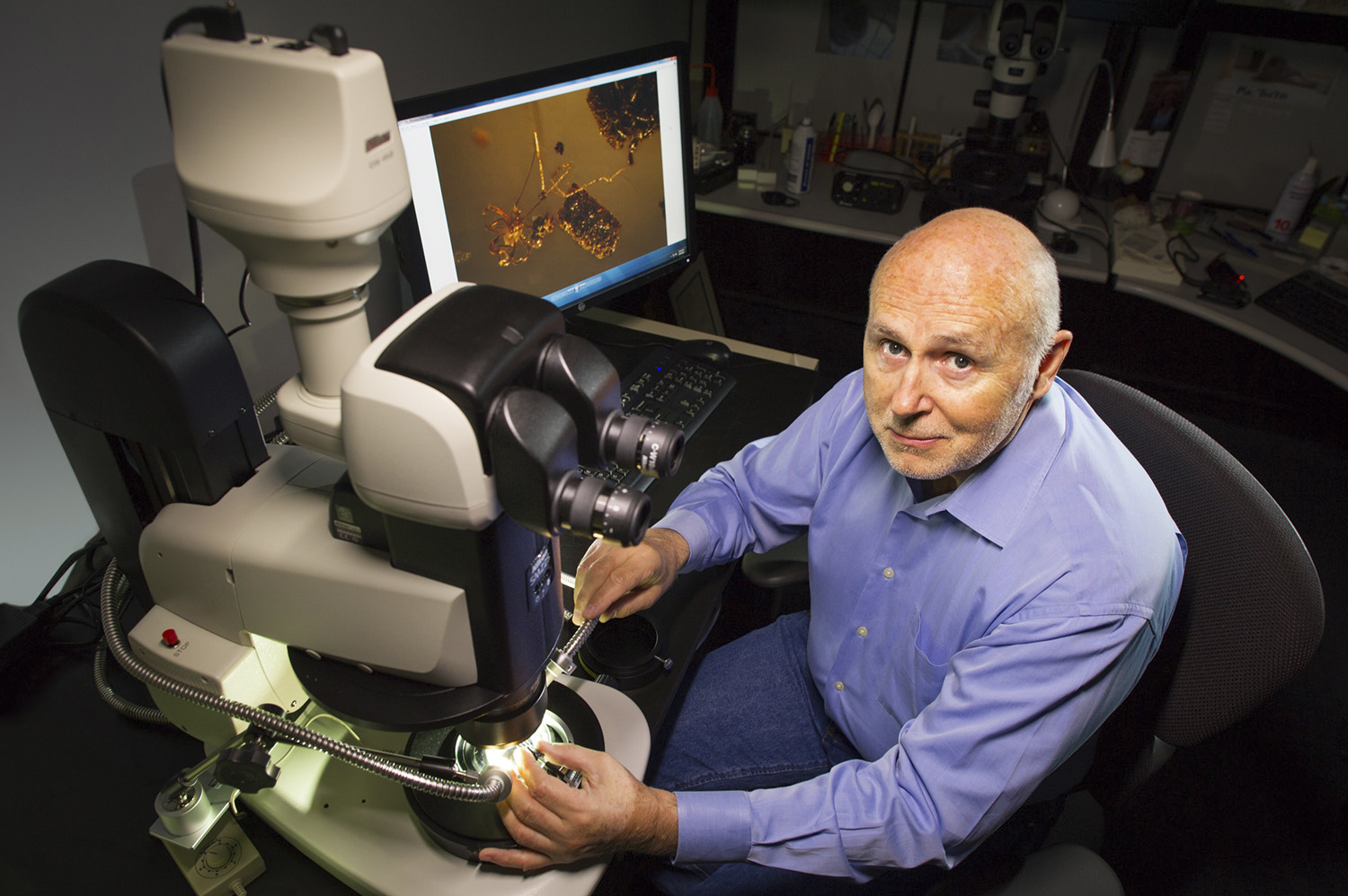 The world's foremost authority on inclusions in gemstones, John Koivula, with his advanced Nikon SMZ25 stereoscopic microscope with built-in image stacking capability. Image stacking is commonly used today to increase the depth of field for a medium that has extreme limits due to the high magnification.