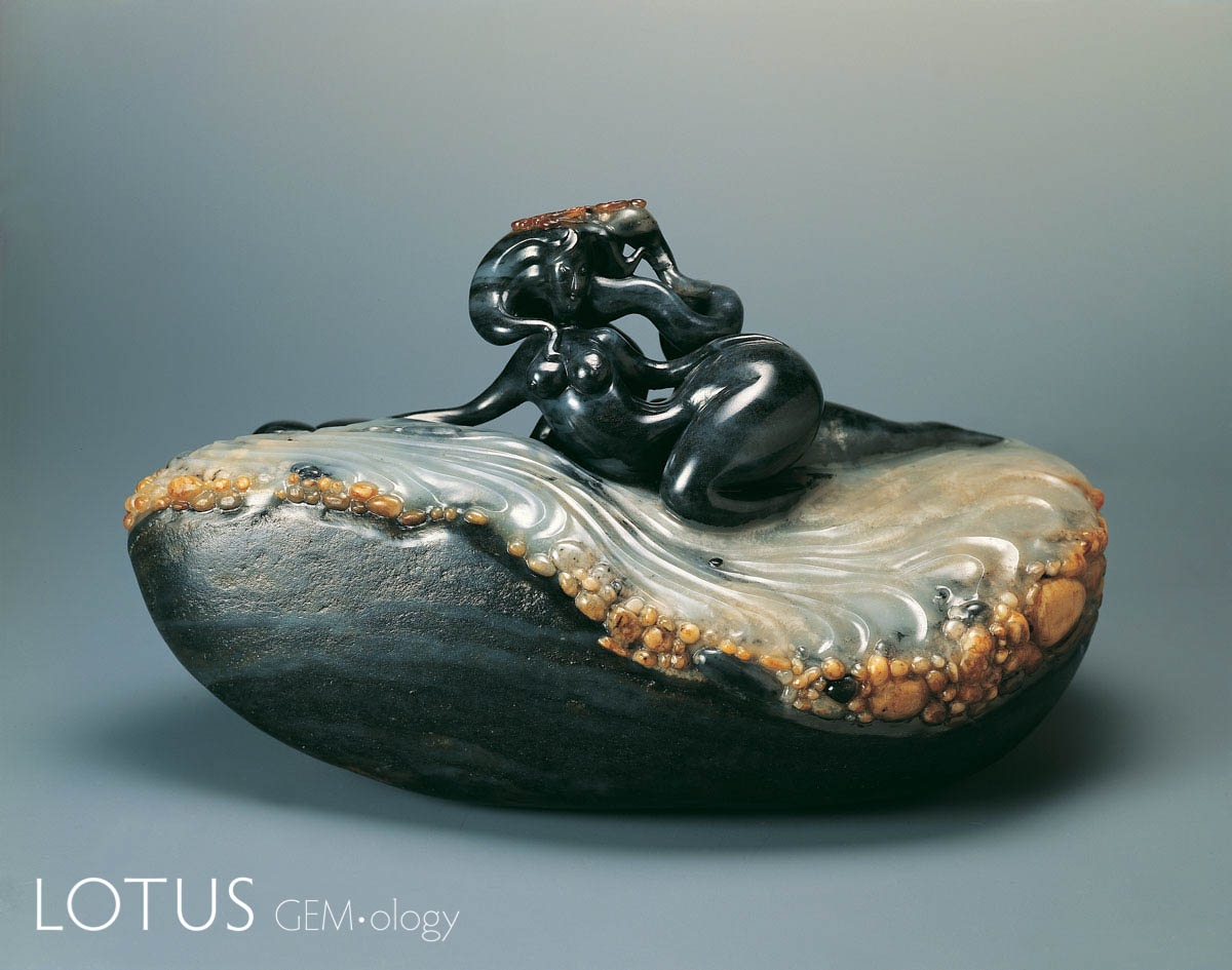 Beauty on the Beach by Wu Desheng. This carving, which is done in nephrite jade from Xinjiang, China (Hetian jade), is an exceptional example of a master carver using the variations in both texture and color of the jade itself to create something transcendent. 19.5 x 11.5 x 9.5 cm; 2006. Photo: Zou Liu. Click on the photo for a larger image