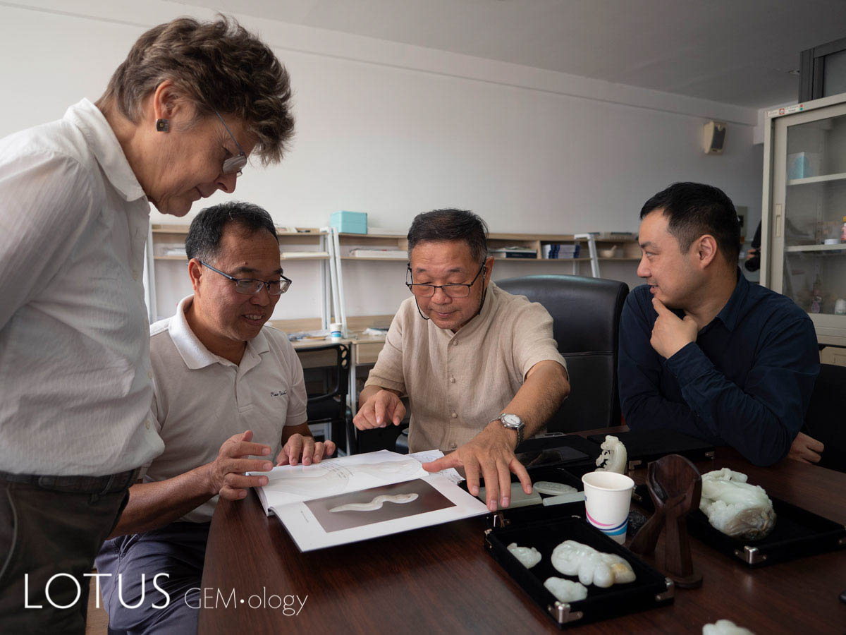 (Left to right) Margaret Sax of the British Museum, examining the jades pictured in Lin Tze-Chuan's book Joyful Forms of Beautiful Jade (2016), with Jason C.H. Kao, Lin Tze-Chuan and Zhou Zhengyu at Shanghai's Tongji Universiity. Tongji Professor Zhou Zhengyu has worked closely with the British Museum to bring contemporary Chinese jade carving to a wider audience. Photo: Richard W. Hughes. Click on the photo for a larger image