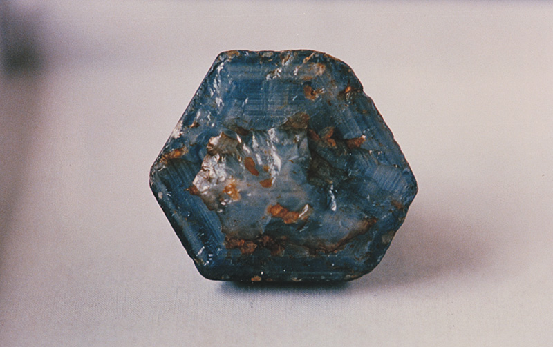 Figure 7. Top: 502-ct Burmese sapphire crystal. This was unearthed on Feb. 22, 1994, at Khabine, near Gwebin, in Burma's Mogok Stone Tract. Below: The base of the crystal, showing concentrations of silk. (Photos: U Khin Mg Win)