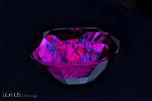 After this ruby grew, it was exposed to high pressure, causing certain planes of atoms to glide into a twinned position. This secondary “polysynthetic” twinning takes place along the rhombohedron faces and is common in many corundums. Twin planes cross at 86.1 and 93.9° angles.