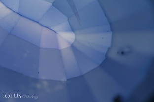 Color concentrations around facet edges in this lattice-diffusion treated synthetic sapphire.