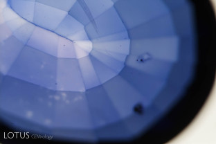 Color concentrations around facet edges in this lattice-diffusion treated synthetic sapphire.