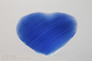 Curved color banding in a Verneuil-grown synthetic sapphire.
