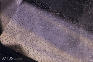 A delicate fingerprint decorates the interior of this blue sapphire from Madagascar. This represents a secondary inclusion, one that formed via the healing of a fissure after the host gem had formed. Its undamaged nature demonstrates that this stone has not been subjected to high-temperature heat treatment.