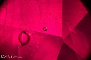 Heat-altered fingerprints and melted crystals embellish the interior of this heat-treated Thai-Cambodian ruby.