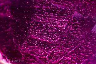 Douros synthetic flux ruby overgrowth on a natural seed. The overgrowth is quite thin and the interface shows tiny spots in lines.
