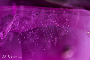 A heat-altered fingerprint lies just below the surface of this Tajikistan ruby.