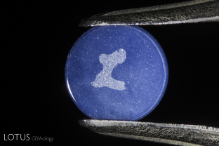 The engraved “L” on the back of a genuine Linde synthetic star ruby. All of the Linde production featured this branding.