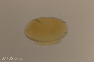 When a yellow sapphire is immersed in a yellow liquid like methylene iodide, it is difficult to see the growth zoning, as shown here.