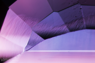 The most distinctive feature of hydrothermally grown synthetic corundum is wavy growth zoning.