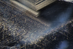 Undissolved rutile silk in particles and needles in angular zones; this is a common sight in Tunduru sapphire.
